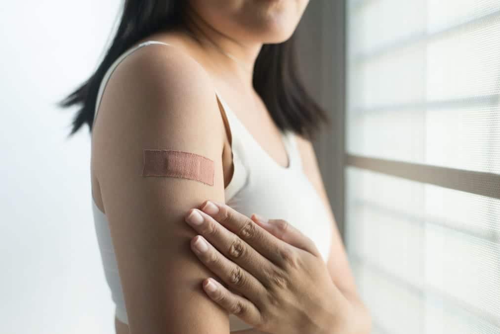 woman-using-adhesive-bandage-plaster-on-her-arm-after-injection-vaccine_t20_6YAoV2