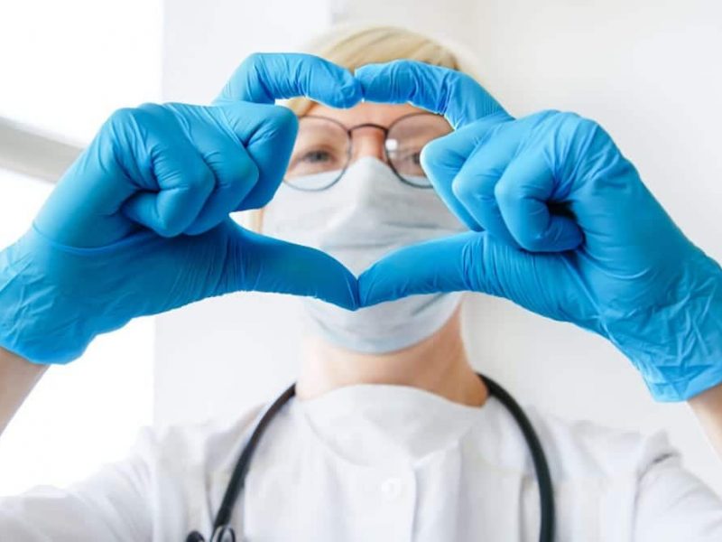 smiling-woman-doctor-in-a-medical-coat-mask-and-stethoscope-showing-hands-heart-shape-medicine-love_t20_4ege6R