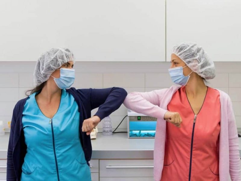 two-young-medical-workers-practicing-social-distancing-greeting-with-elbows-elbow-greeting-mask-masks_t20_WgPLaz